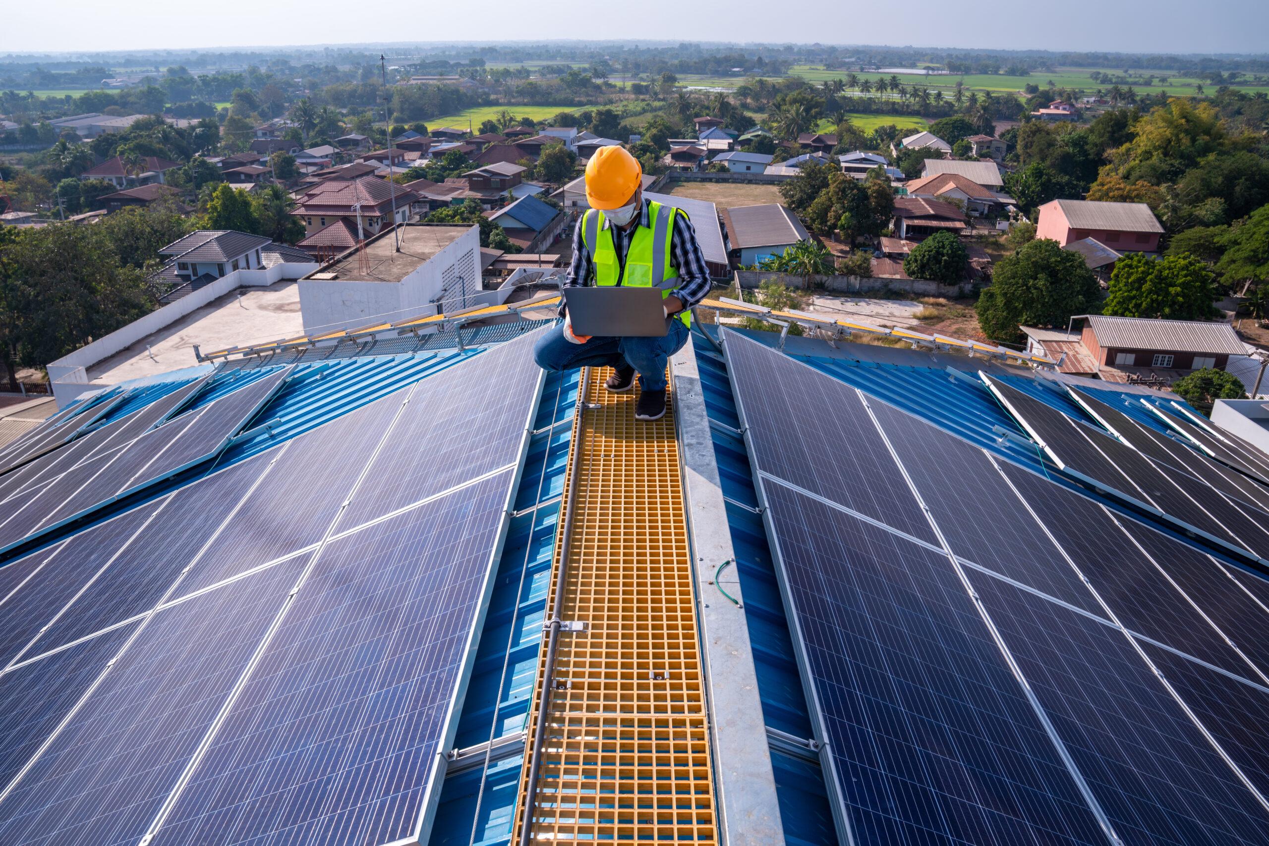 Asian technician checks the maintenance of the solar panels on t